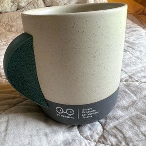 YY Vertical Rock Climbing Speckled Coffee Mug with Green Handle